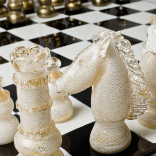 black and white chessboard sculpture with gold details