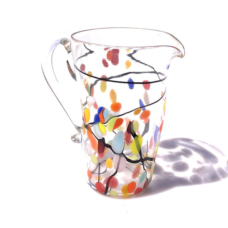 clear glass carafe with colored spots