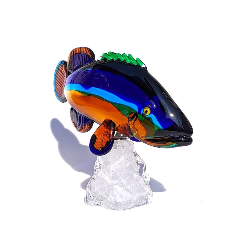 Colored glass fish sculpture on crystal wave base