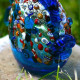 blue glass fish sculpture with multicolor details